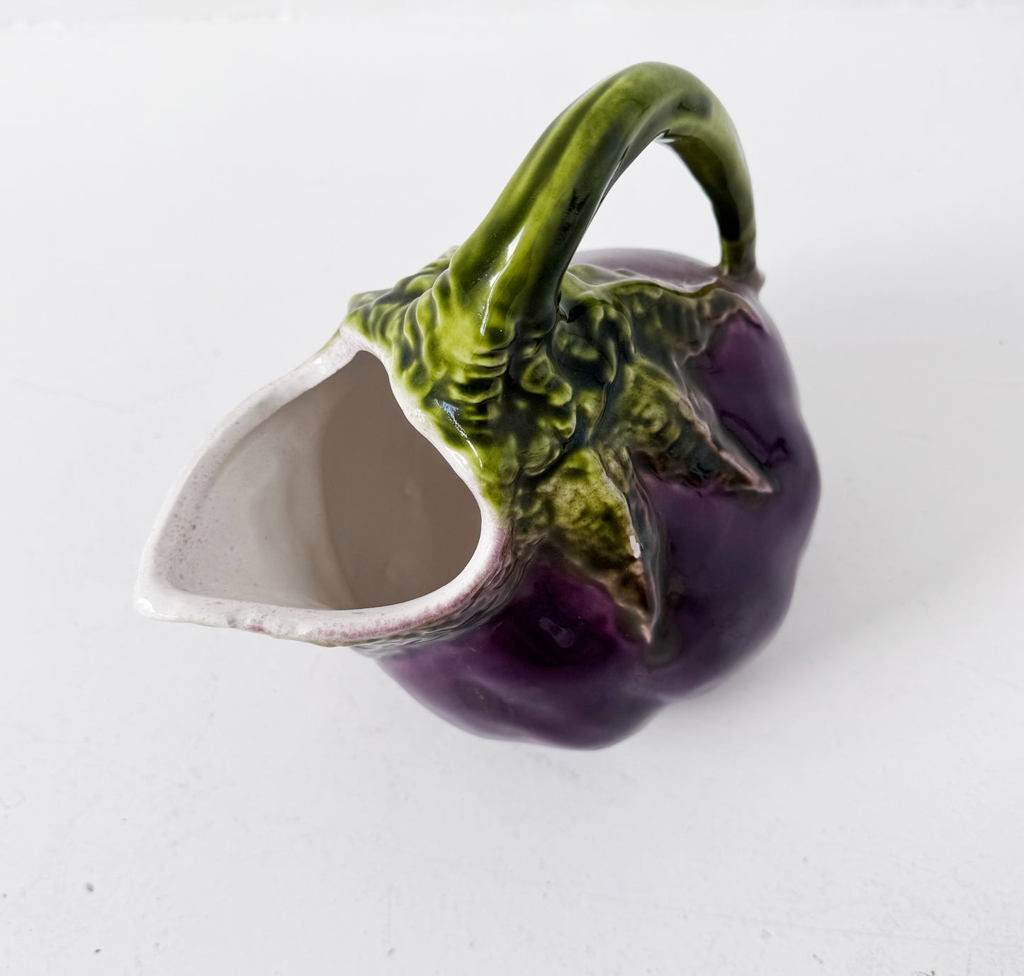 Glazed ceramic pitcher shaped like an eggplant