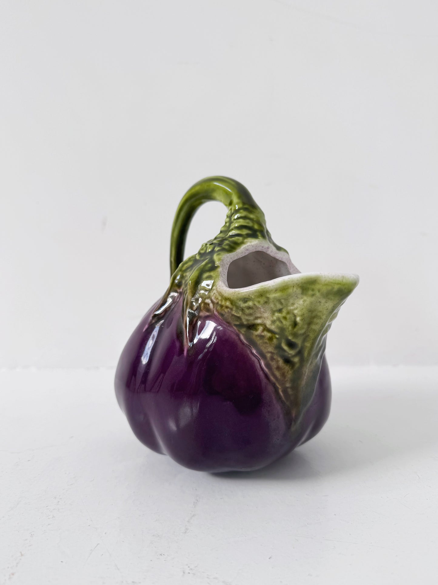 Glazed ceramic pitcher shaped like an eggplant