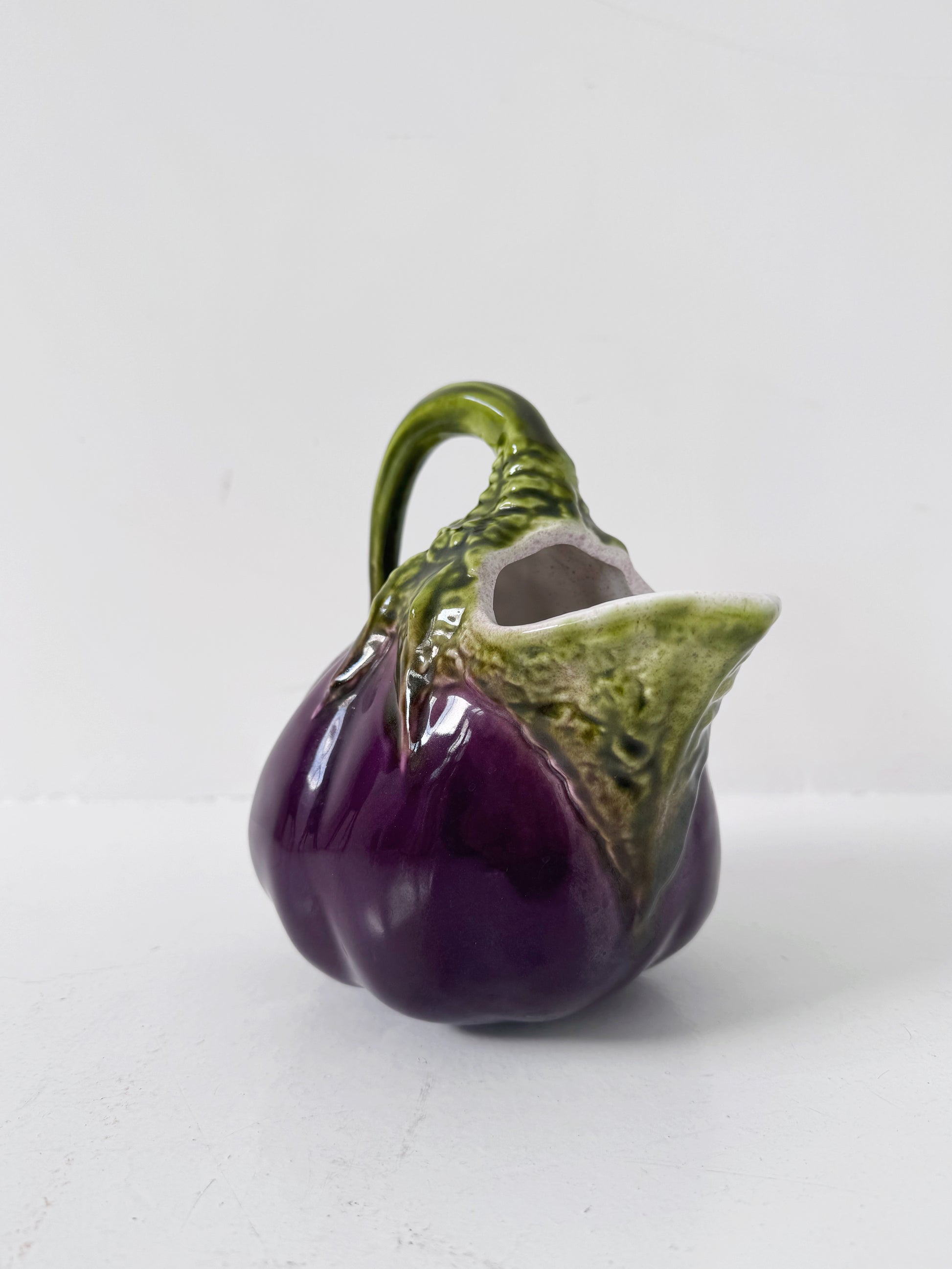 Glazed ceramic pitcher shaped like an eggplant