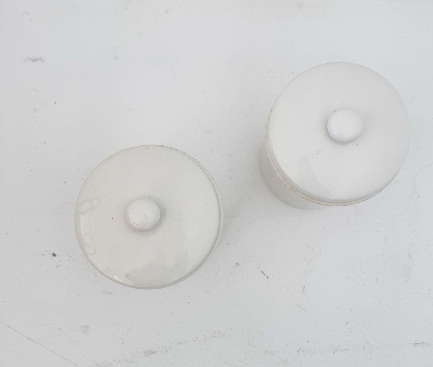 Pair of white ceramic jars with lids