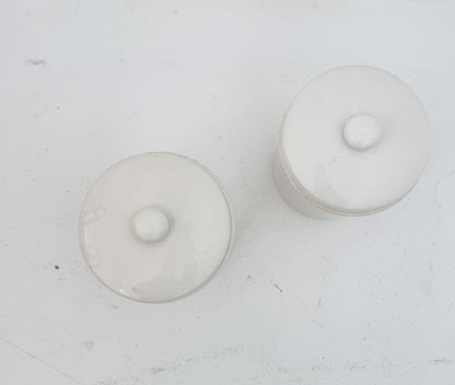 Pair of white ceramic jars with lids