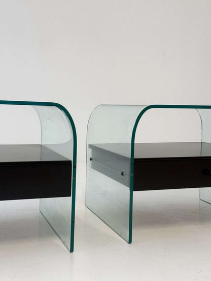 Pair of curved glass coffee tables with black chest of drawers