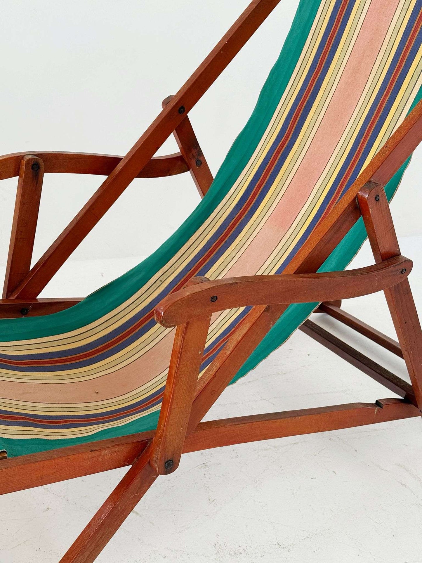 Folding wooden deck chair with striped canvas seat