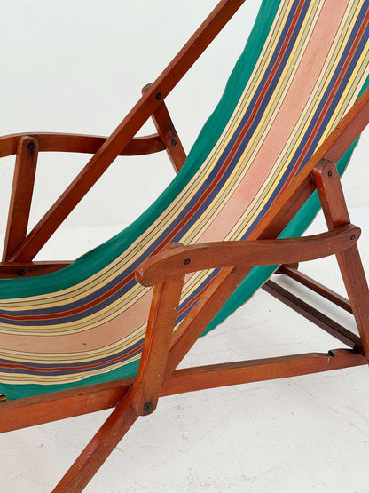 Folding wooden deck chair with striped canvas seat