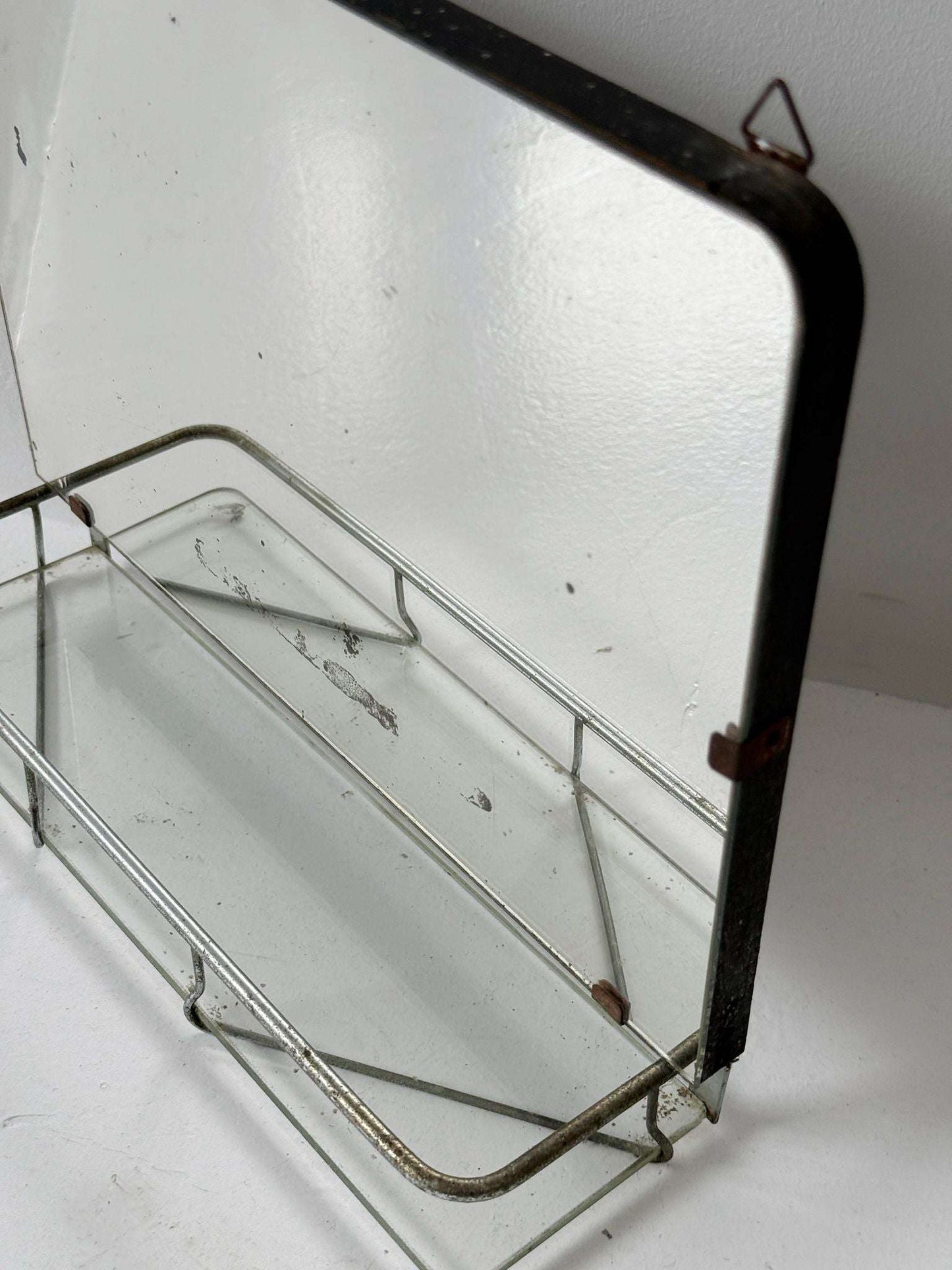Small wall mirror with glass shelf
