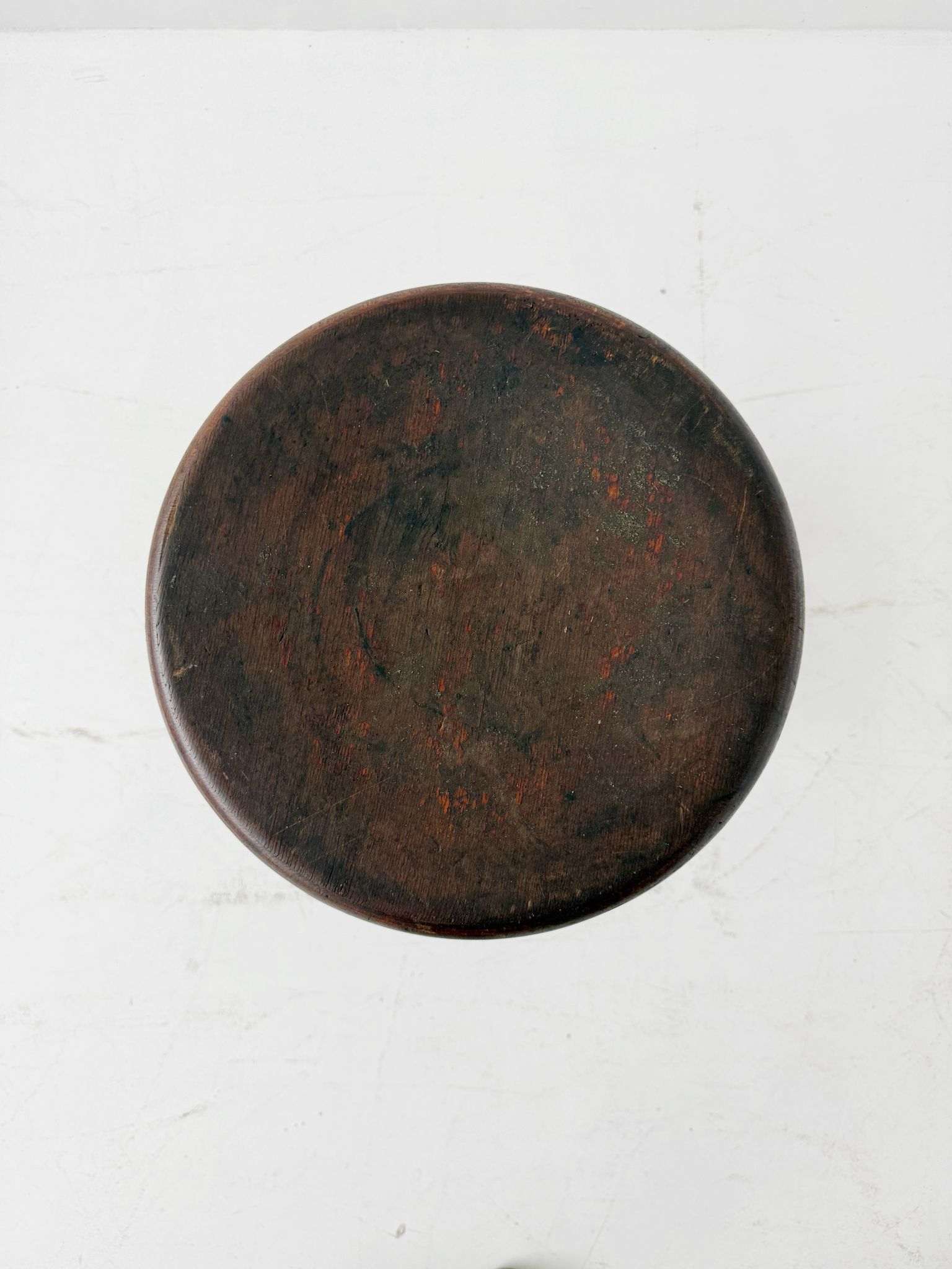 An adjustable industrial stool with a distinctly workshop/laboratory feel, boasting a strong, authentic presence.