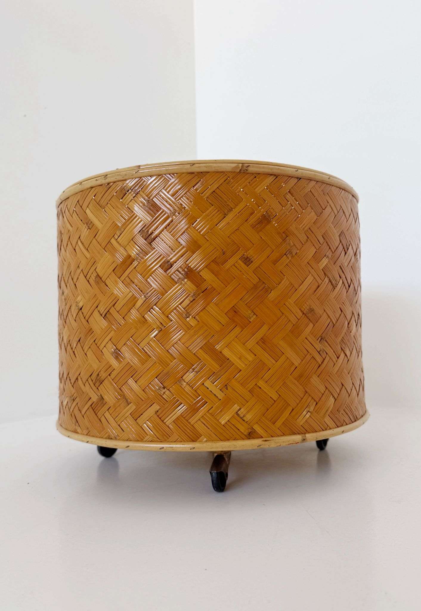 Woven wicker flower stand with wheels