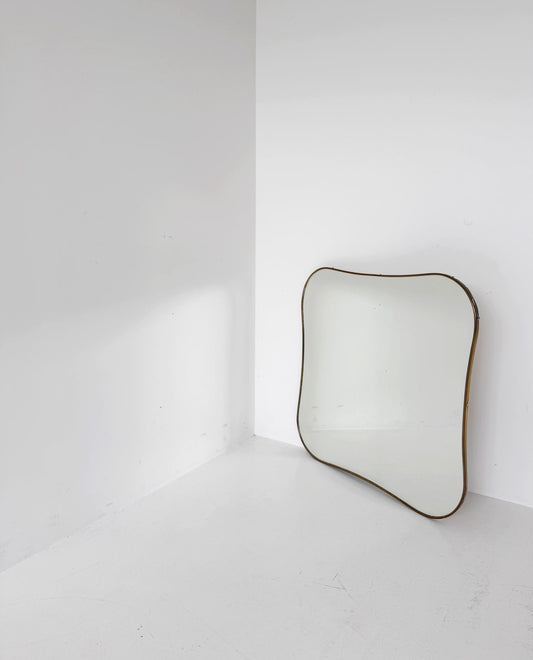 Shaped vintage mirror with a gold-tone frame
