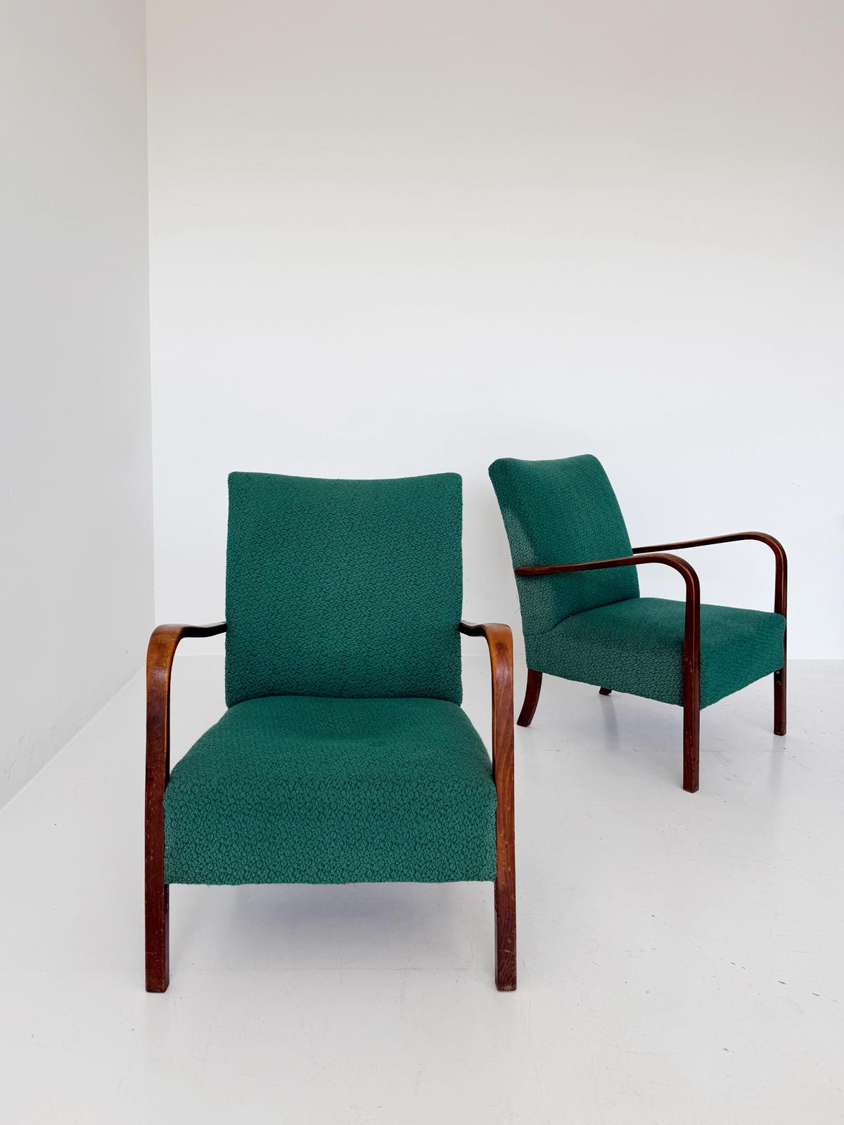 A pair of 1950s Italian armchairs featuring a simple and elegant line
