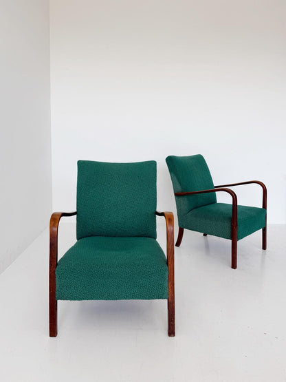 A pair of 1950s Italian armchairs featuring a simple and elegant line