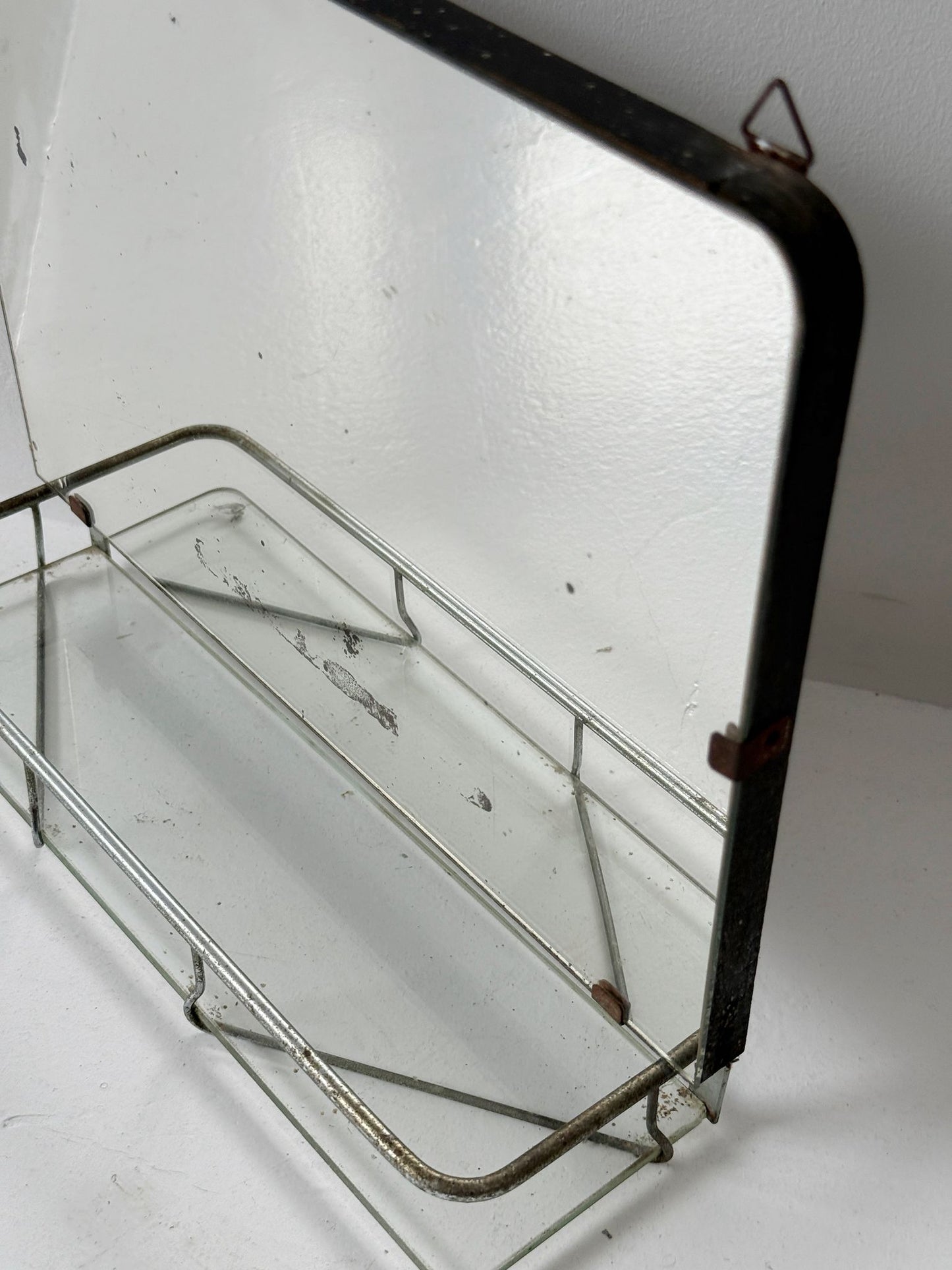 Small wall mirror with glass shelf