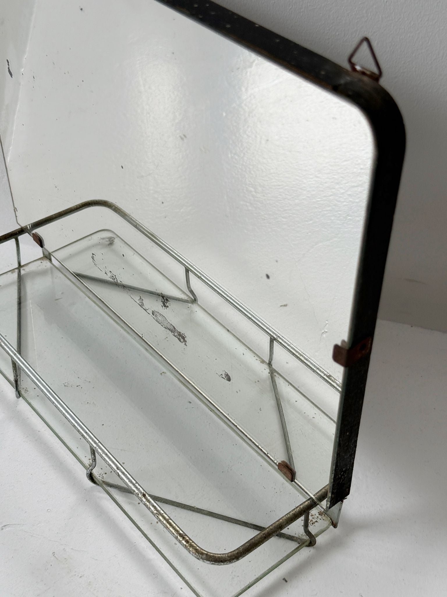 Small wall mirror with glass shelf