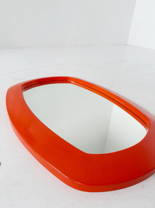Vintage mirror with an orange molded plastic frame