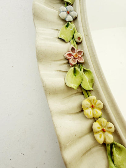 Oval mirror in enamelled ceramic