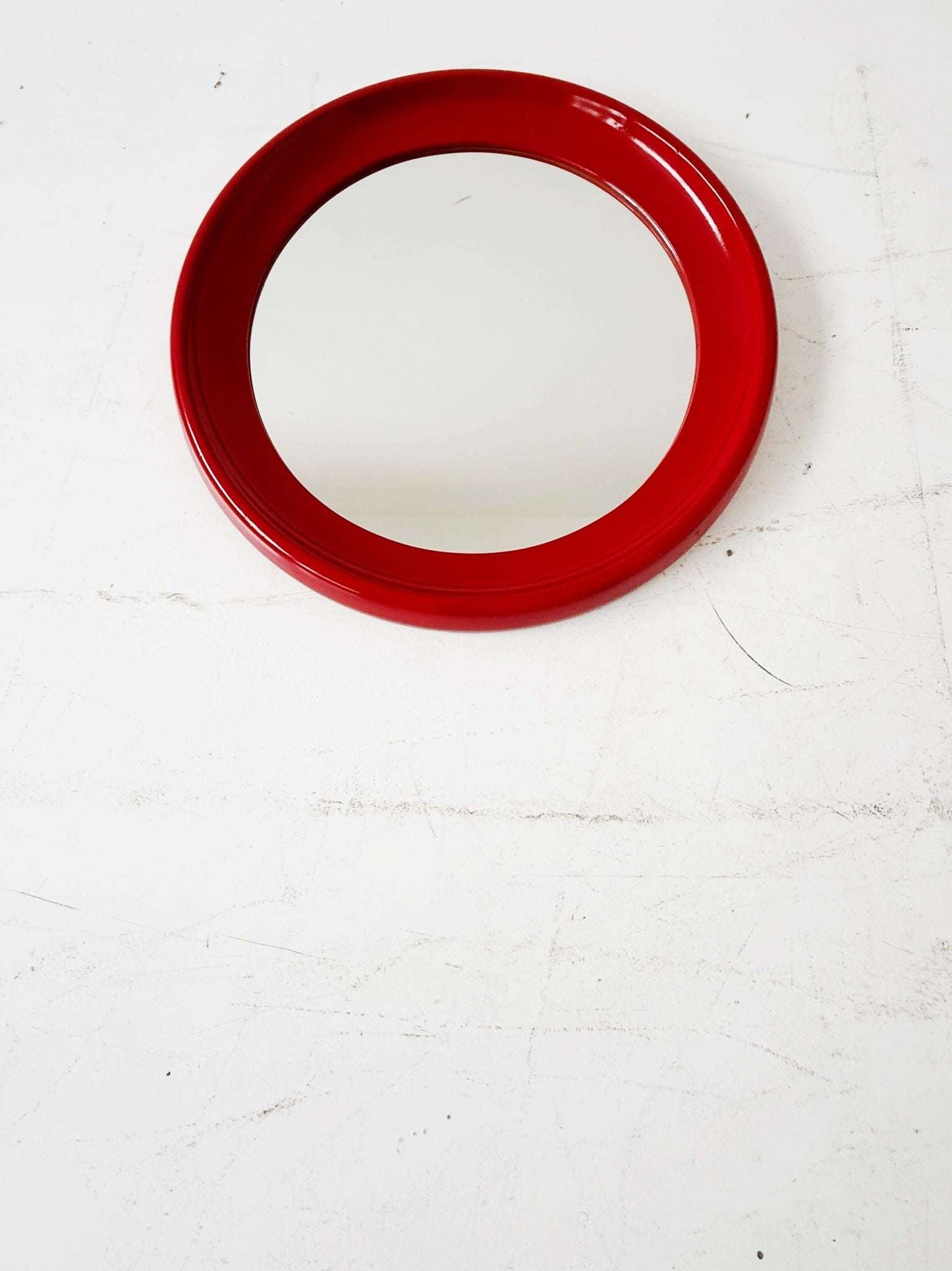 Round mirror with red lacquered frame