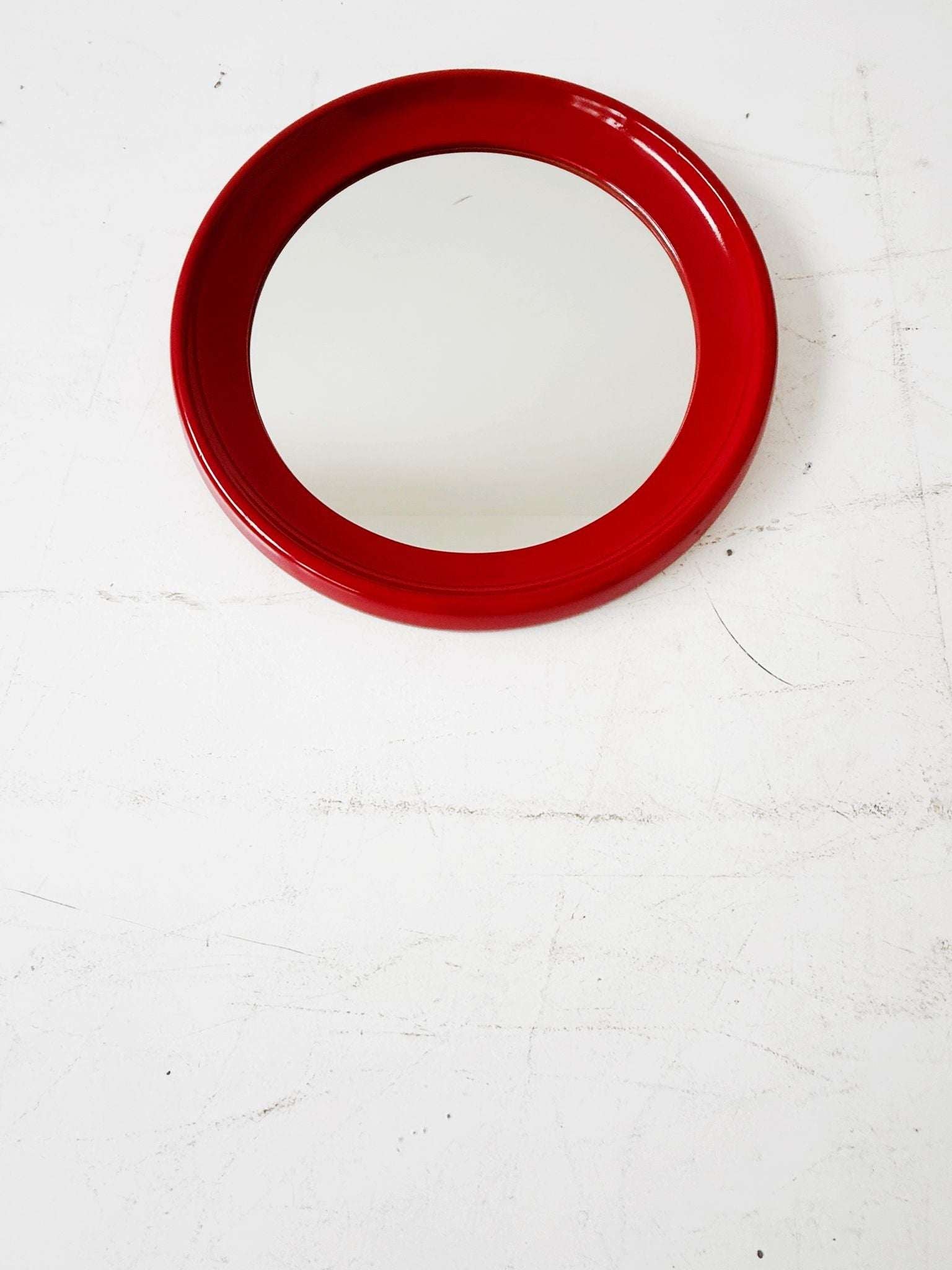 Round mirror with red lacquered frame