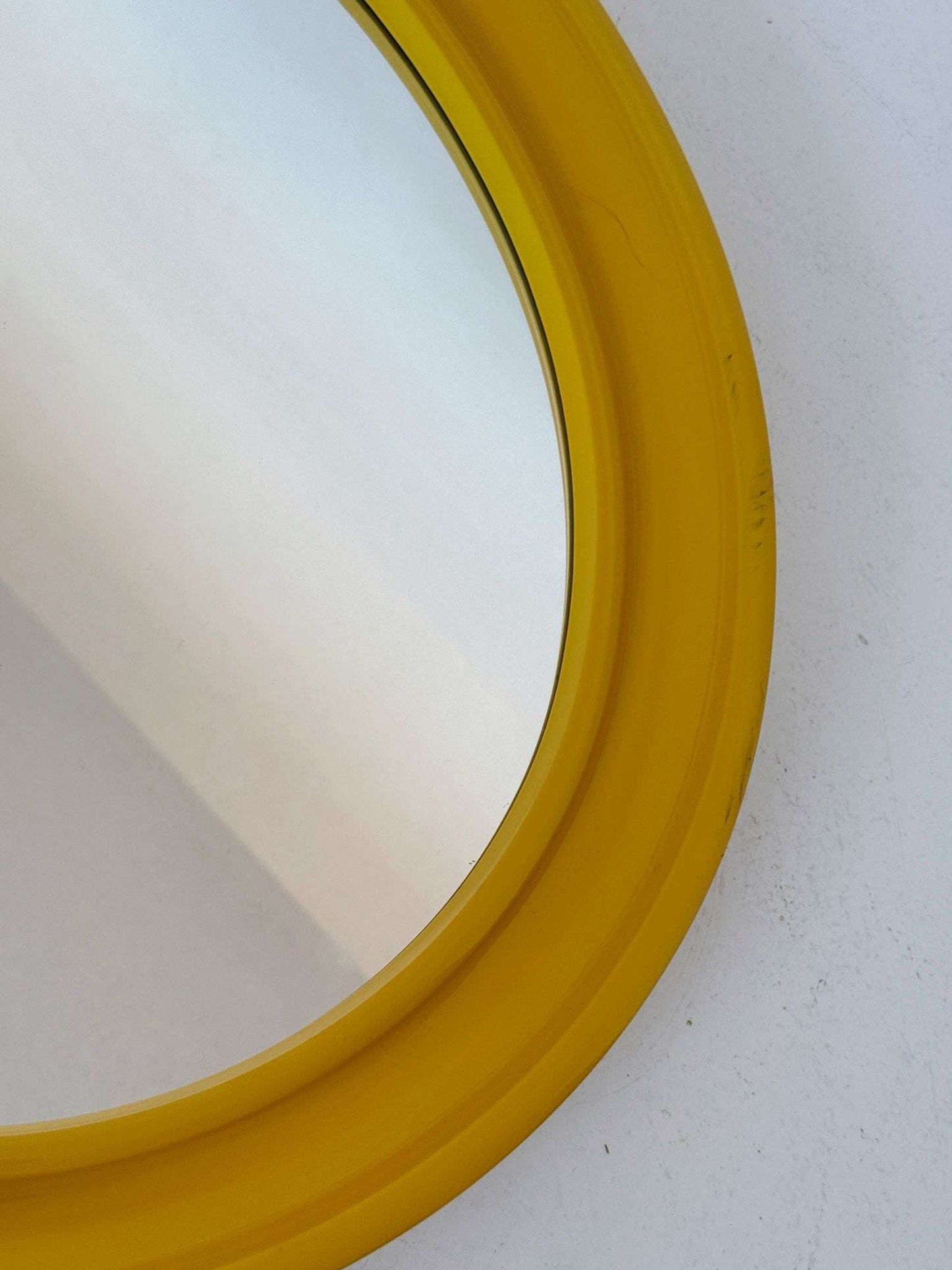 Oval wall mirror with yellow frame