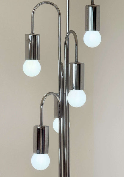 Vintage floor lamp in chromed metal, with a sculptural and luminous design.