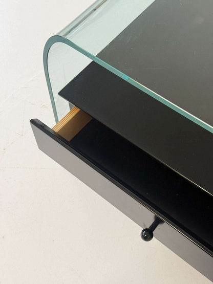 Pair of curved glass coffee tables with black chest of drawers