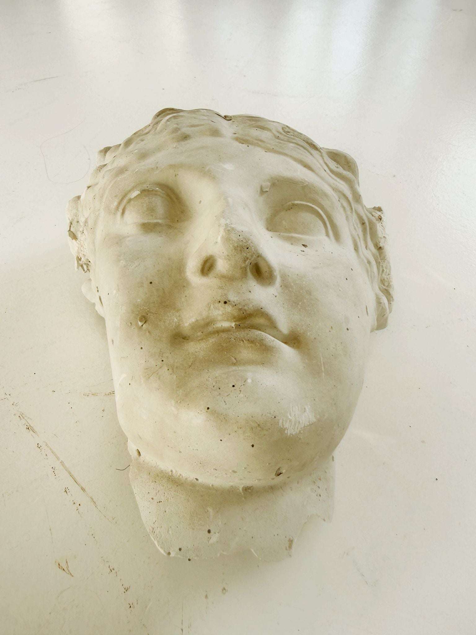 A plaster fragment depicting a female face