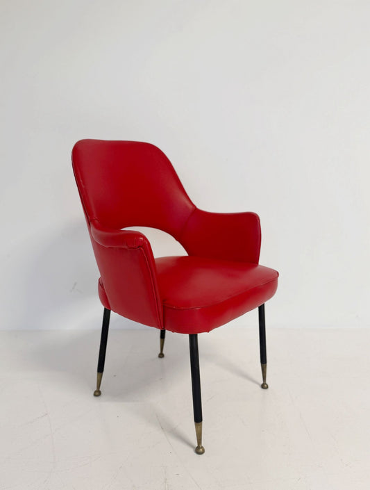 Poltrona italiana anni ’50 in skai rosso, con schienale sagomato e apertura posteriore.