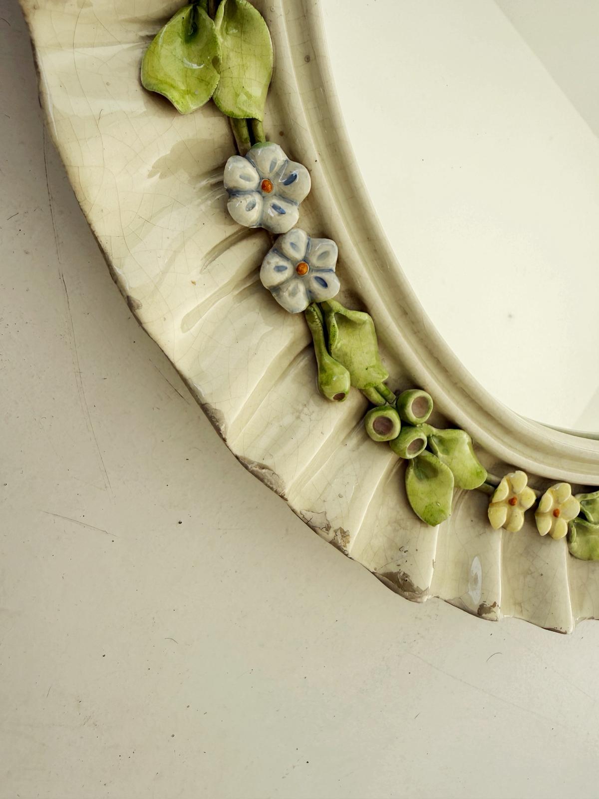 Oval mirror in enamelled ceramic