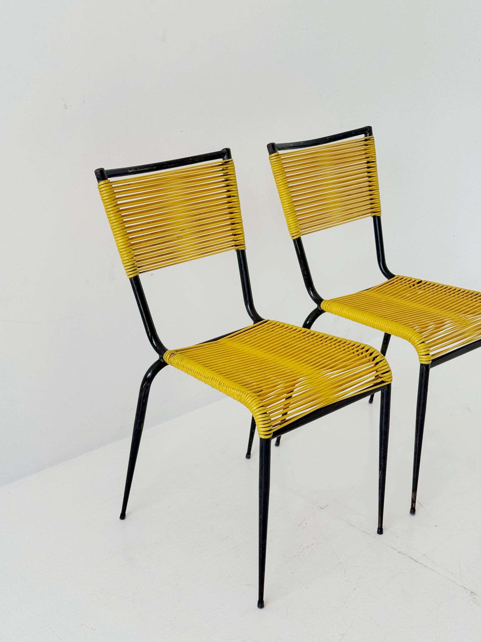 Pair of 1960s design chairs with metal frames and yellow woven detailing