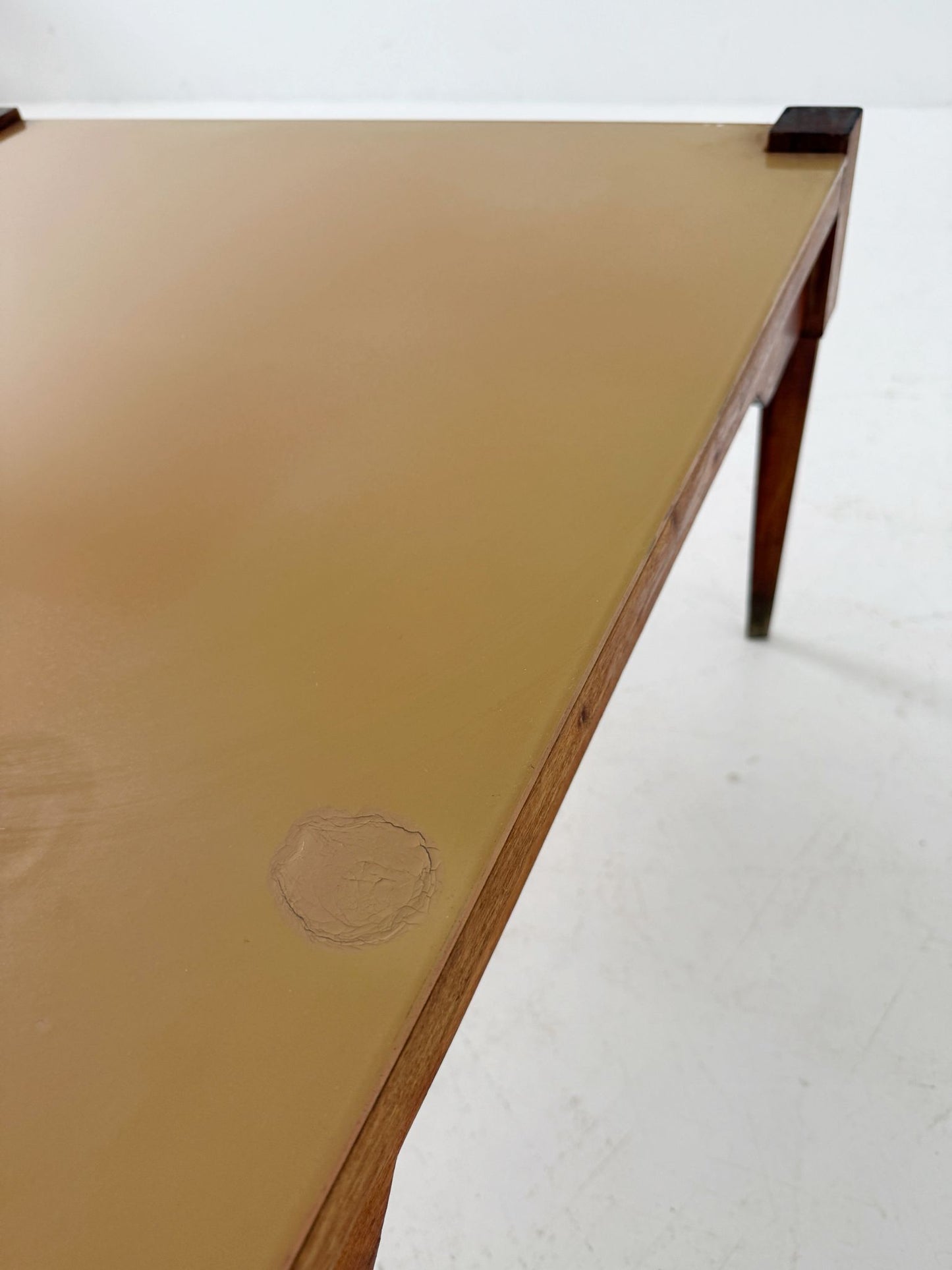 This mid-century coffee table features a solid wood frame and tapered