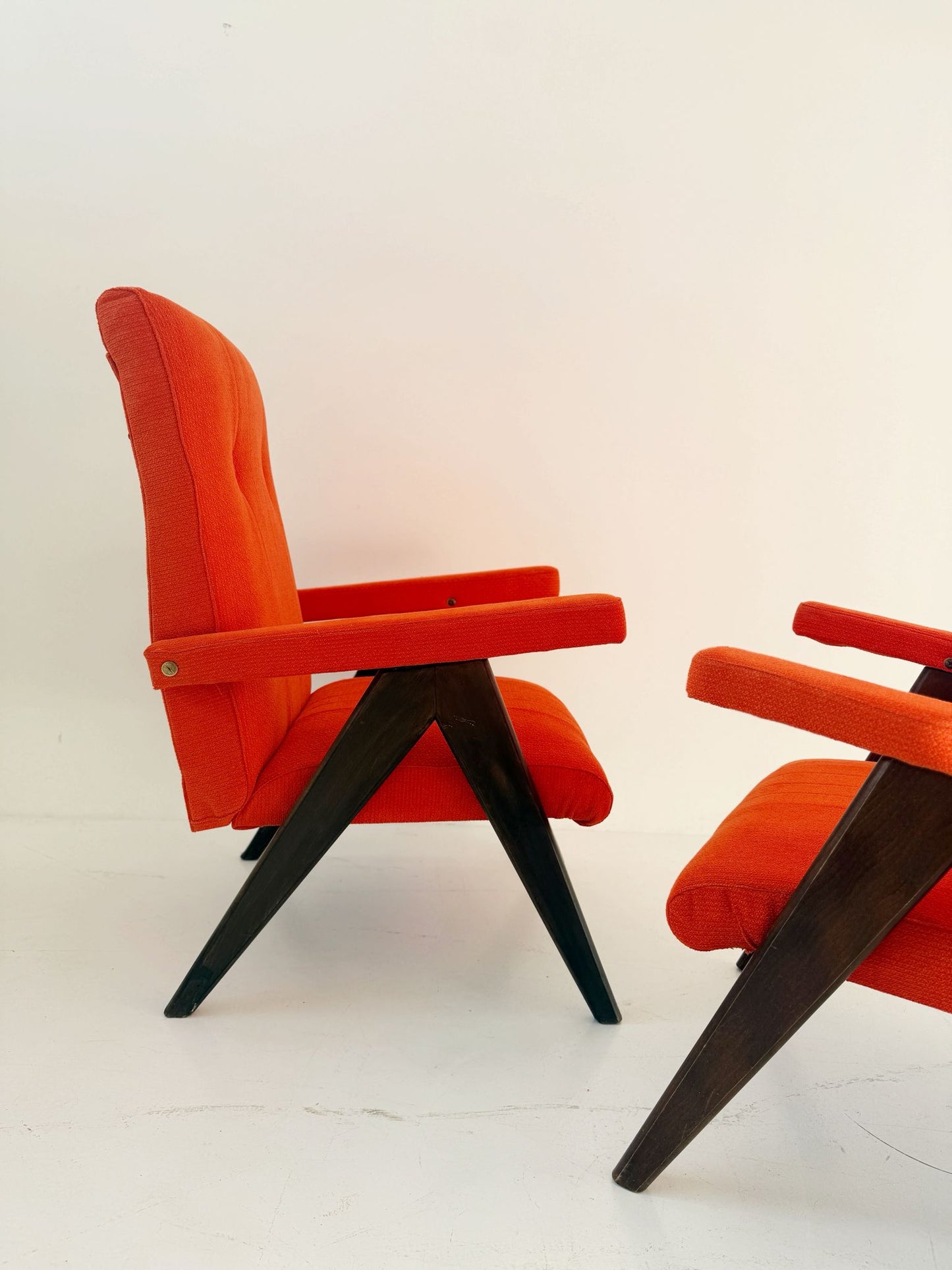 A pair of vintage reclining armchairs