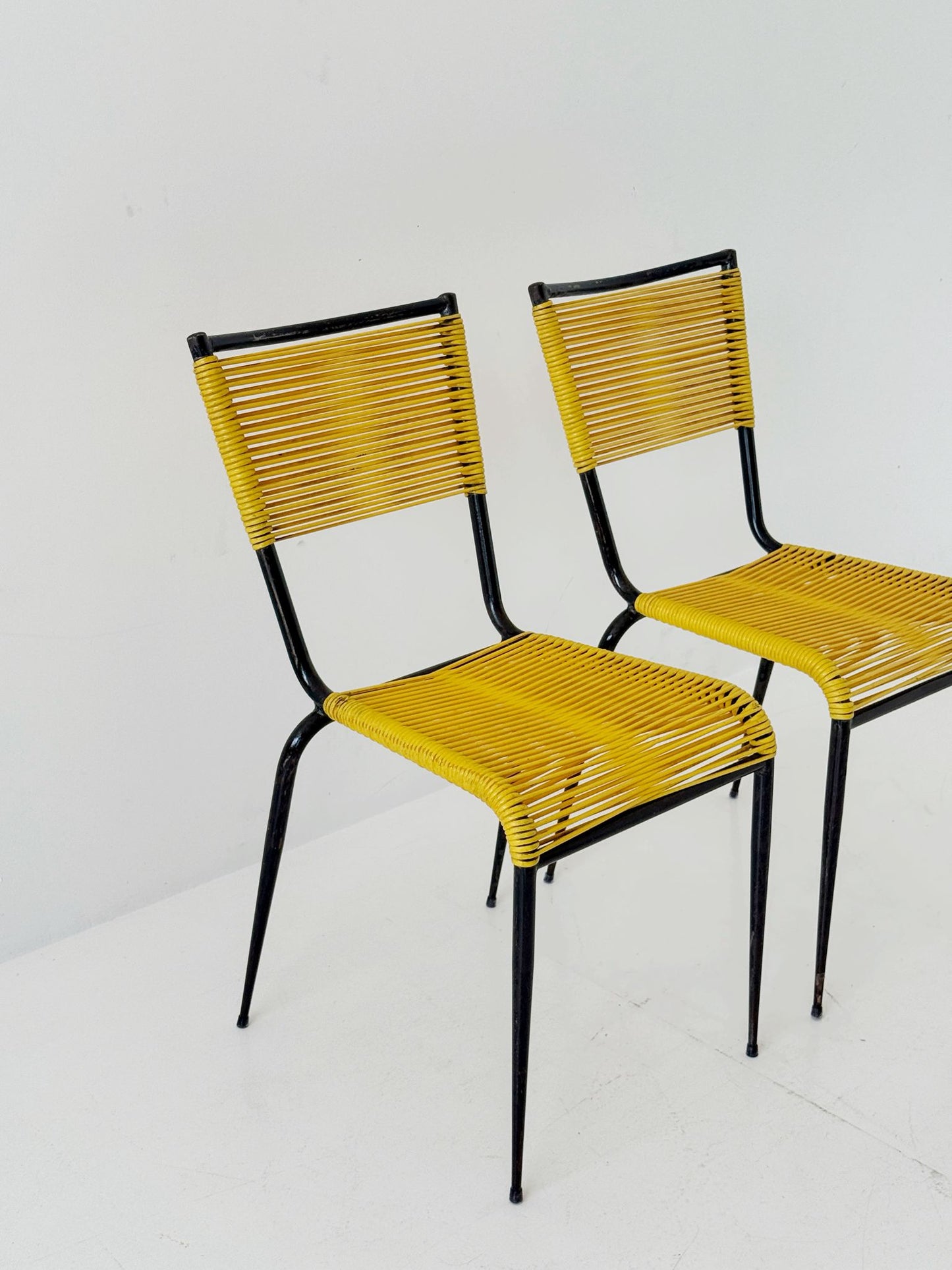 Pair of 1960s design chairs with metal frames and yellow woven detailing