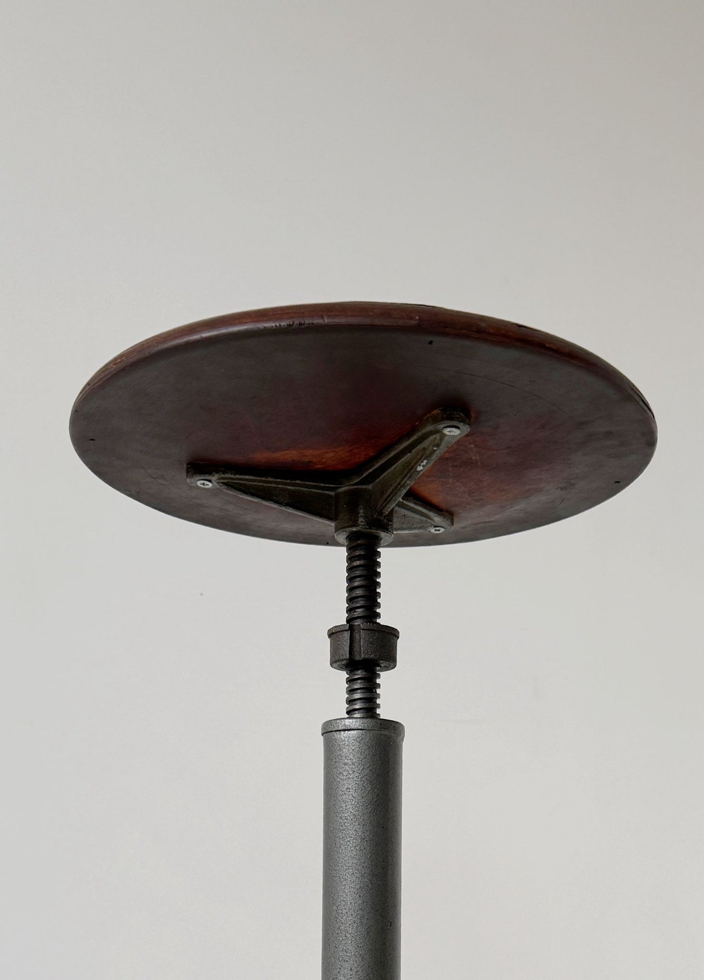 An adjustable industrial stool with a distinctly workshop/laboratory feel, boasting a strong, authentic presence.
