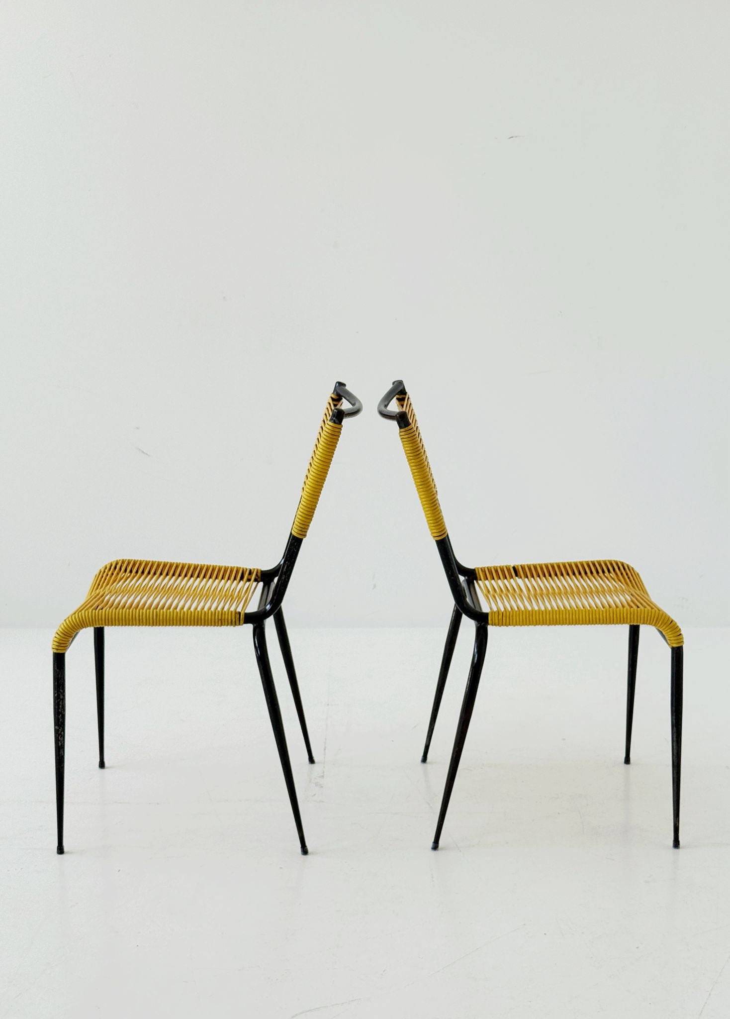 Pair of 1960s design chairs with metal frames and yellow woven detailing