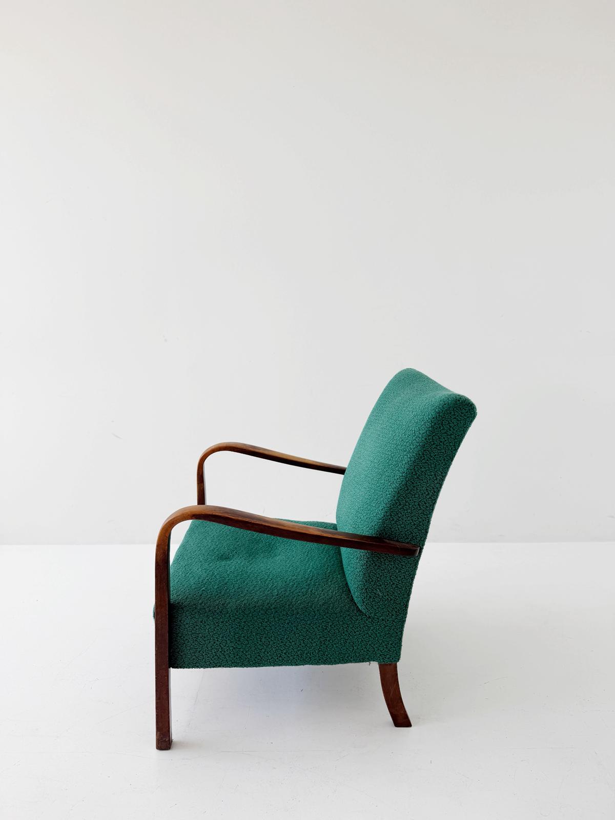 A pair of 1950s Italian armchairs featuring a simple and elegant line
