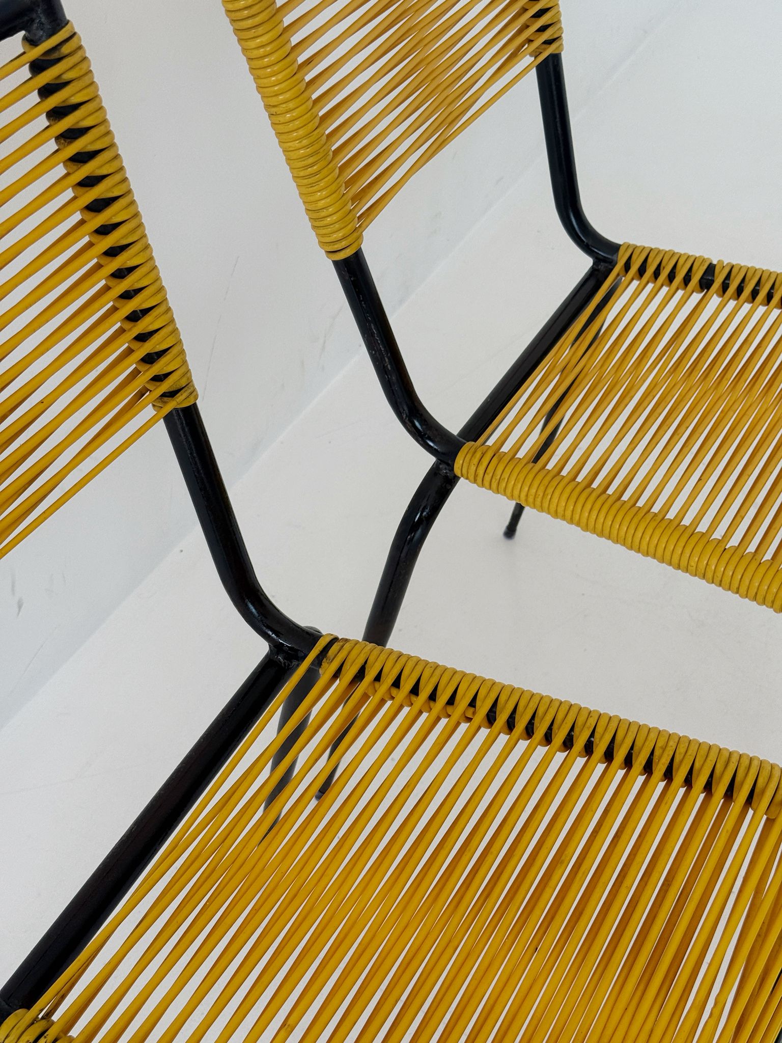 Pair of 1960s design chairs with metal frames and yellow woven detailing