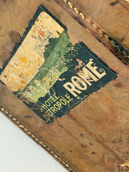 Leather travel suitcase with hotel labels