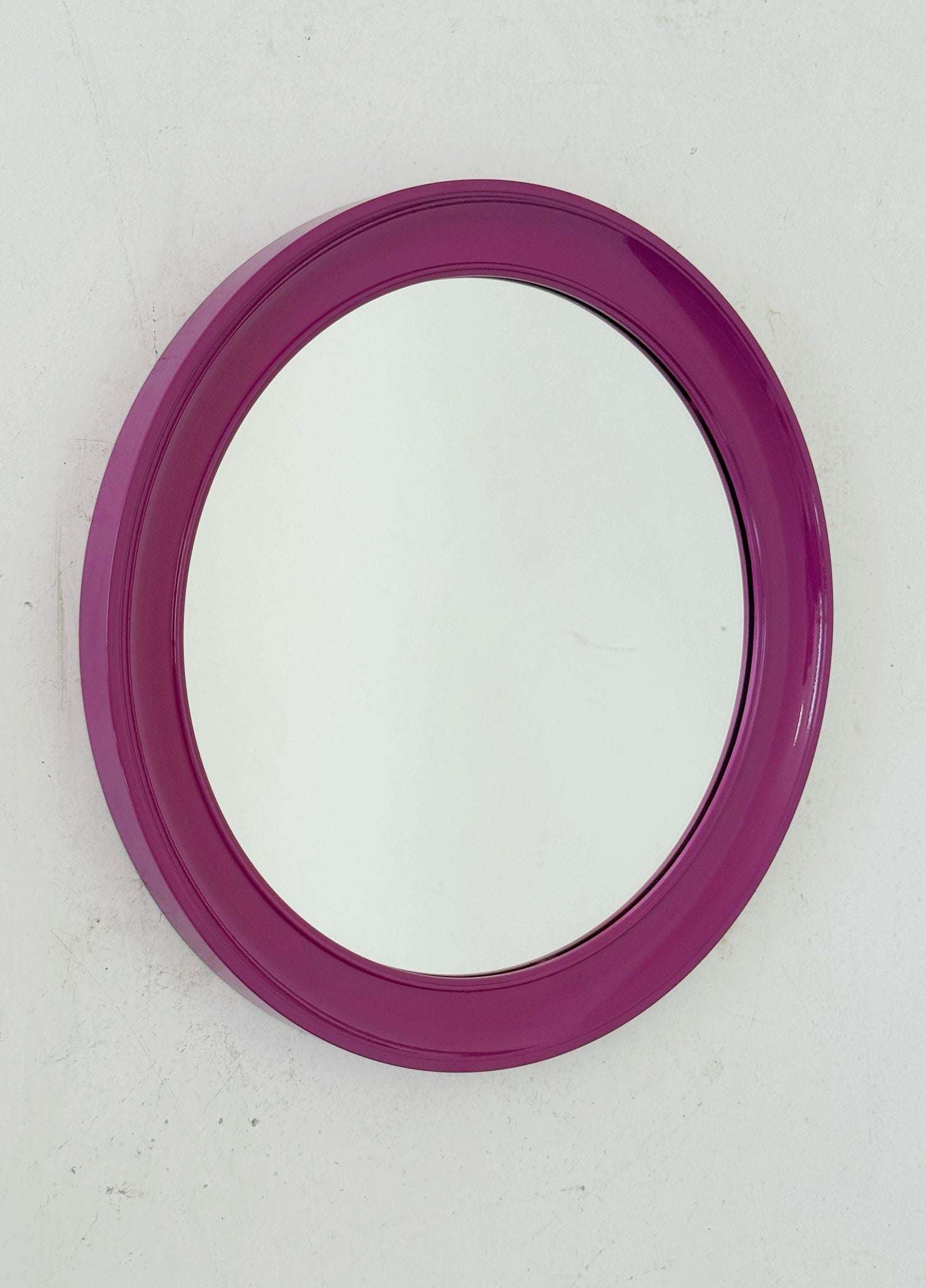Round mirror with purple plastic frame