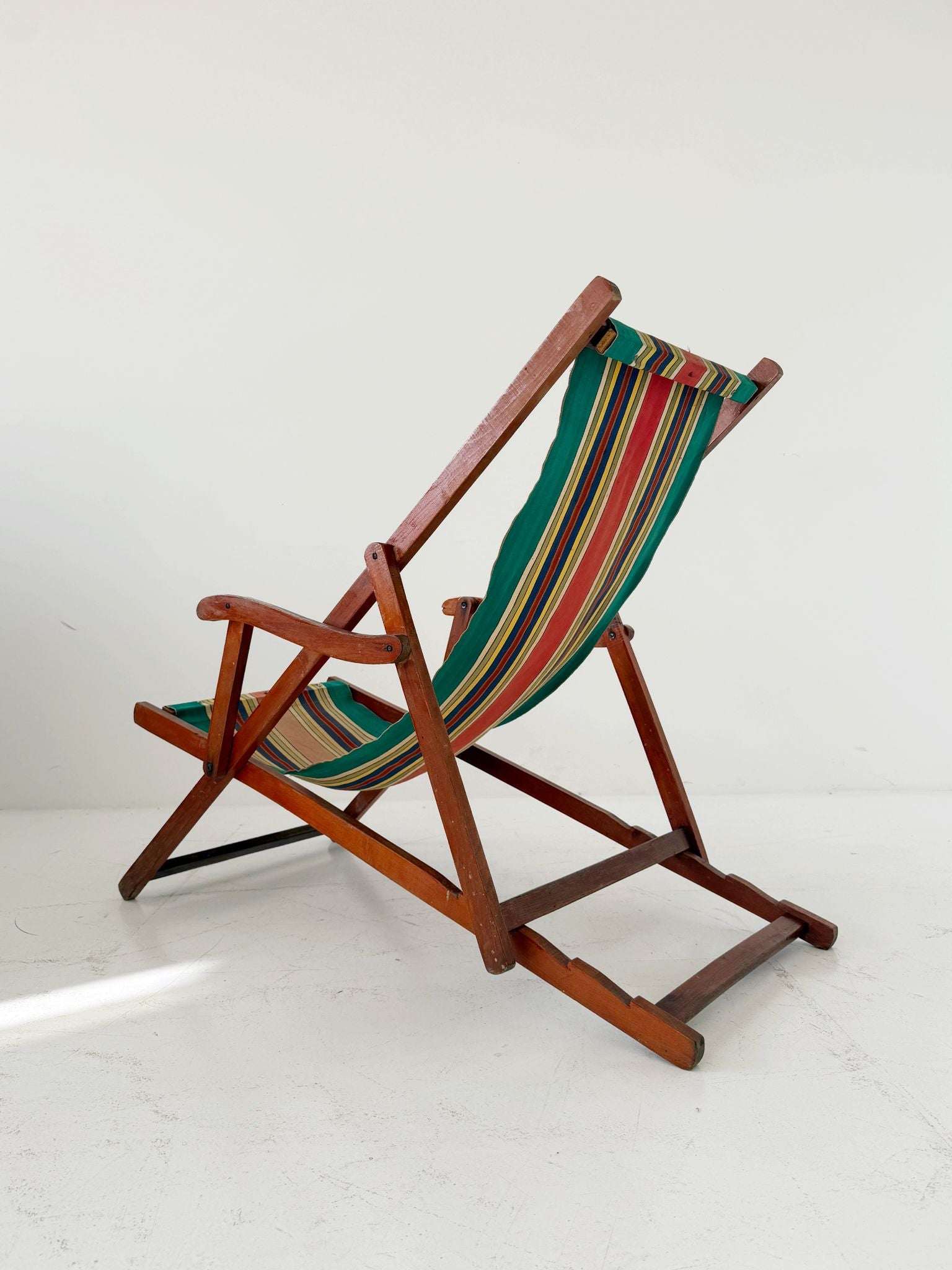Folding wooden deck chair with striped canvas seat