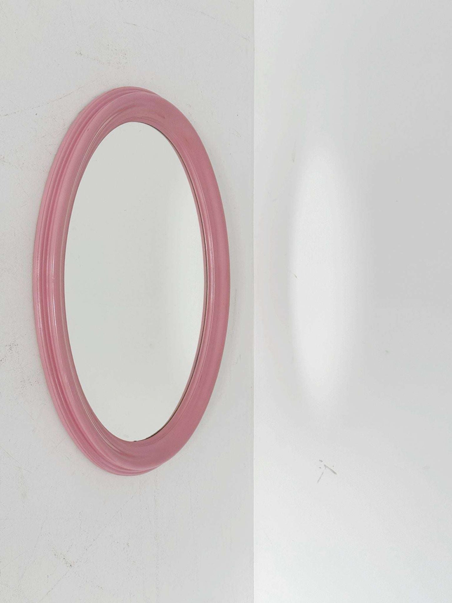 Oval mirror with a powder pink lacquered wooden frame