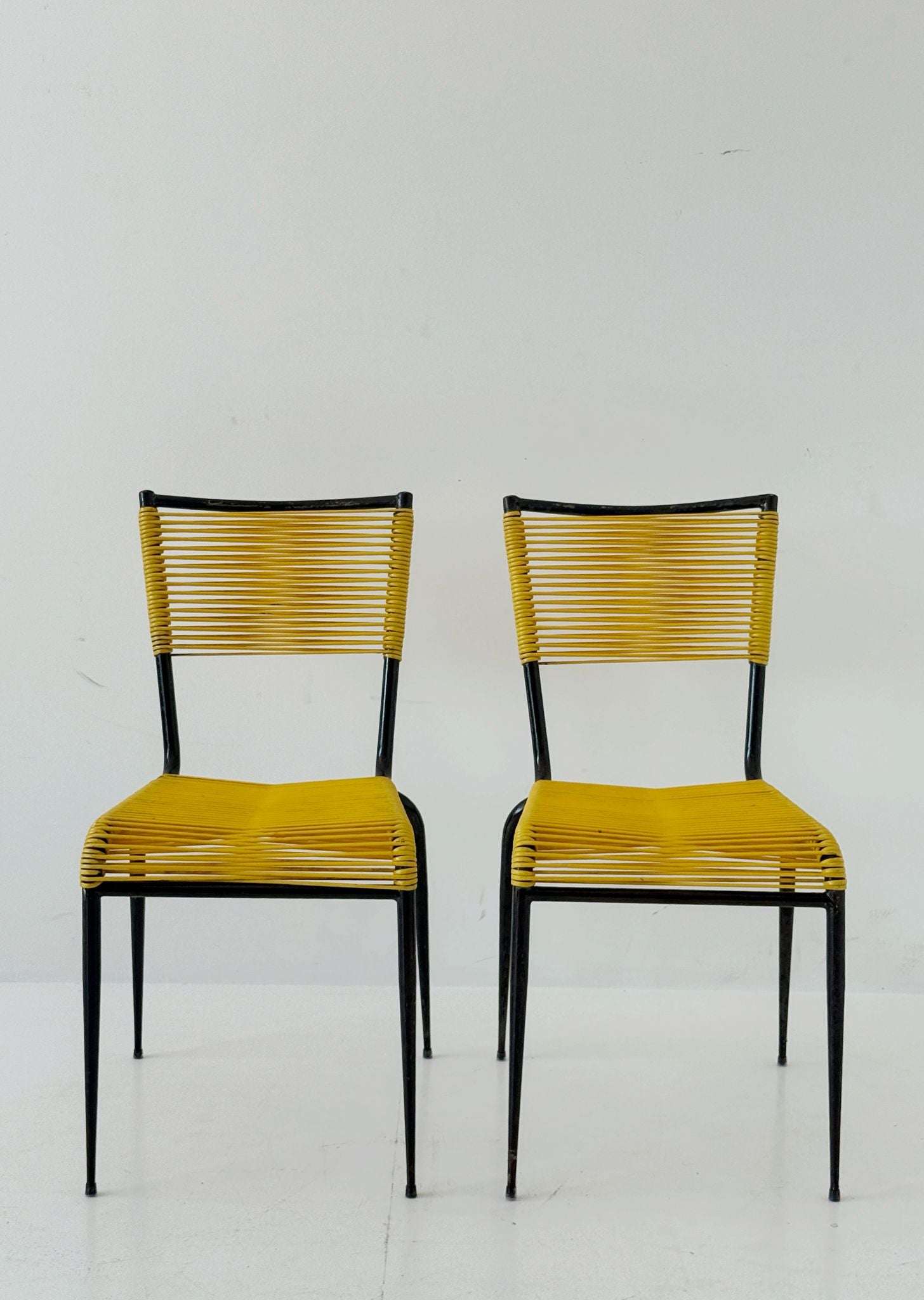 Pair of 1960s design chairs with metal frames and yellow woven detailing