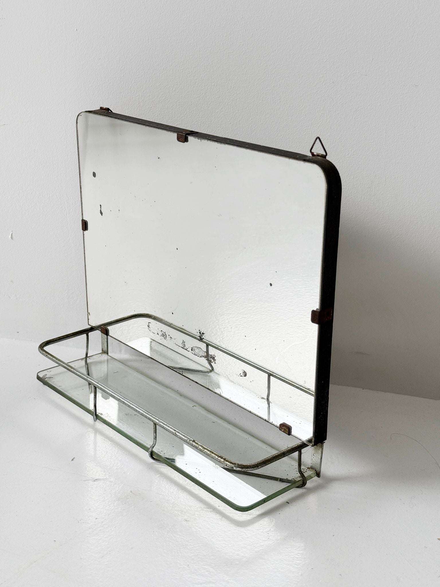 Small wall mirror with glass shelf