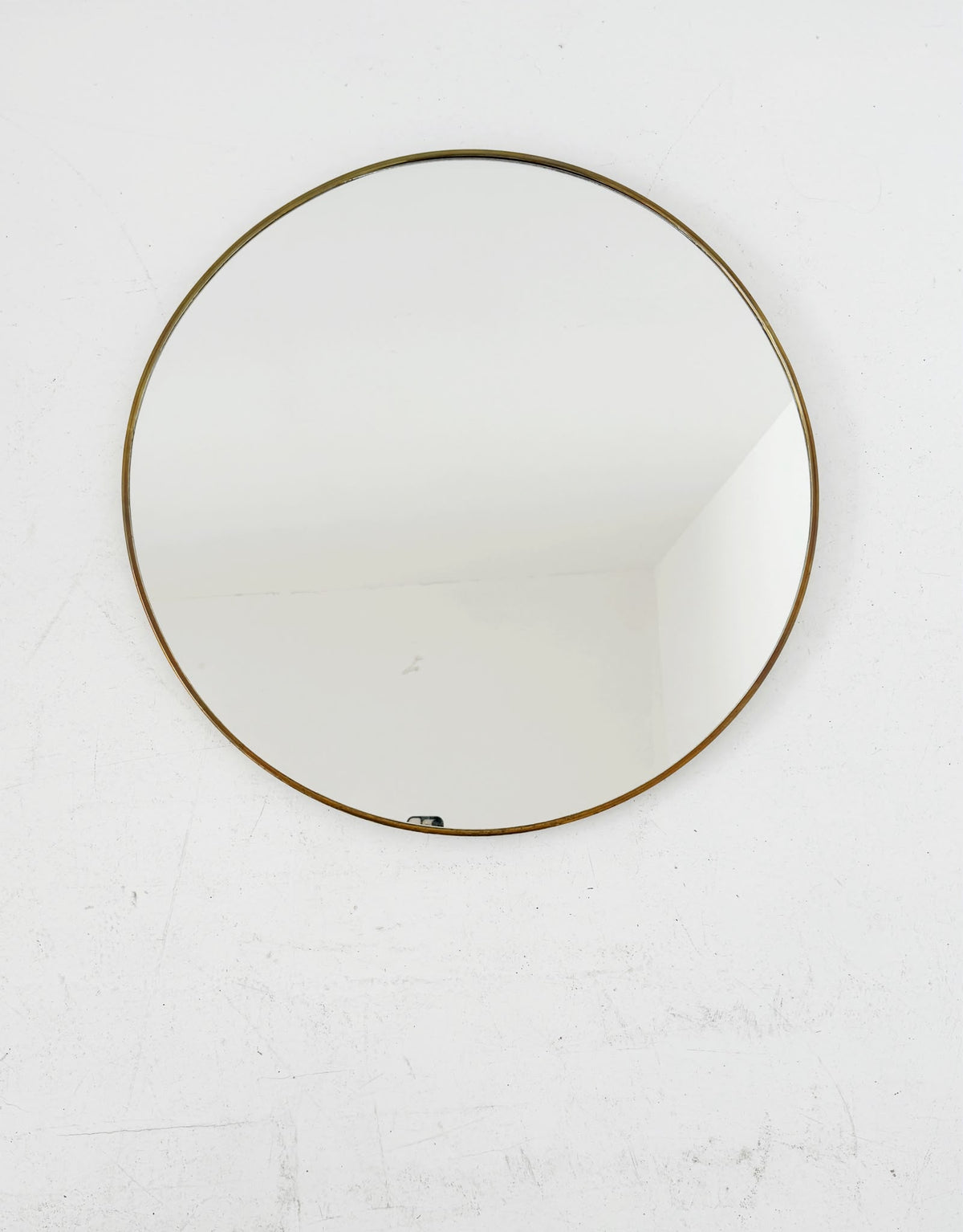 Vintage round mirror with a gold-tone frame