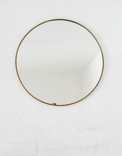Vintage round mirror with a gold-tone frame