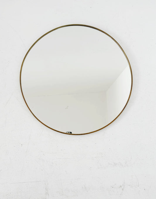 Vintage round mirror with a gold-tone frame