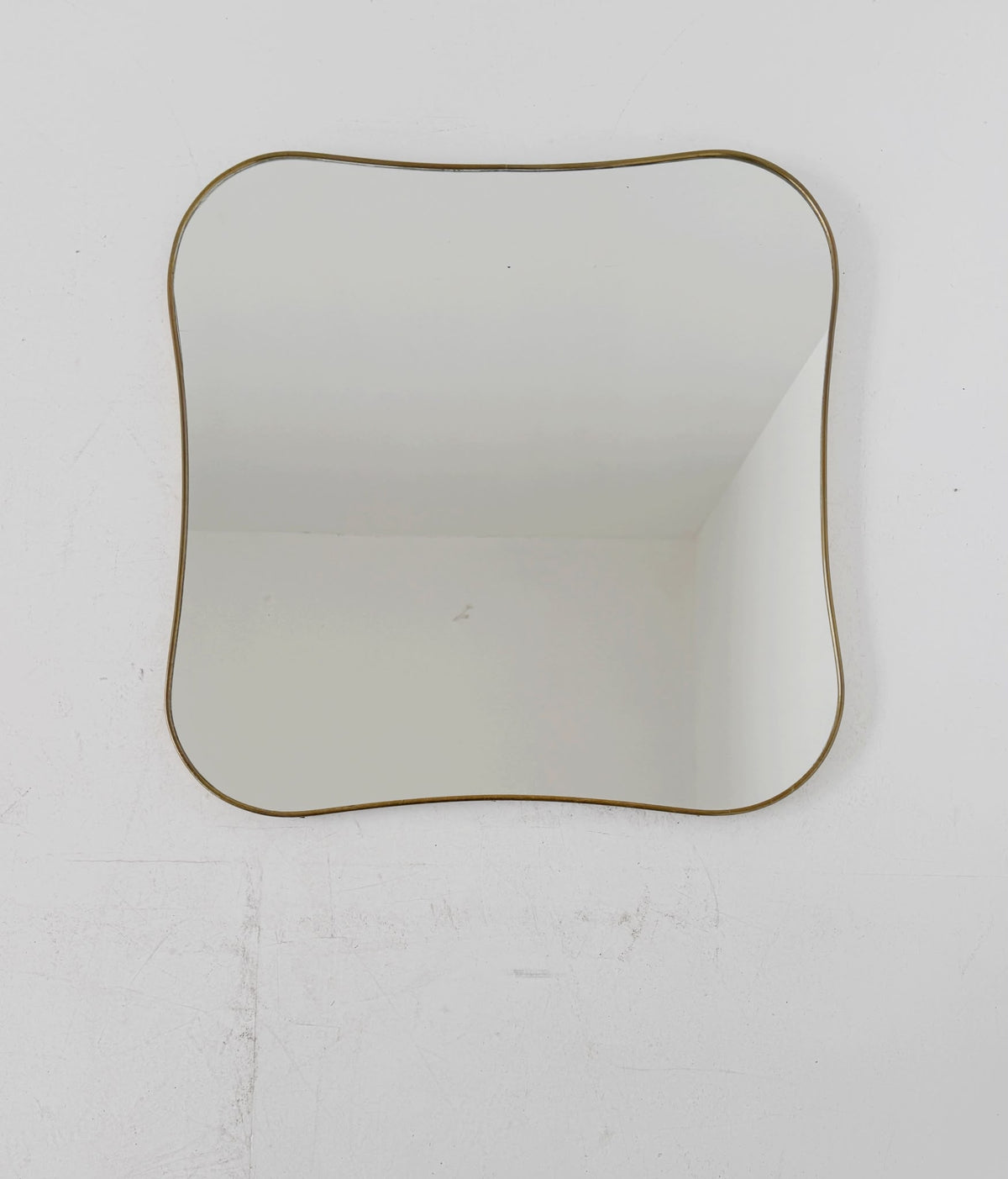 Shaped vintage mirror with a gold-tone frame