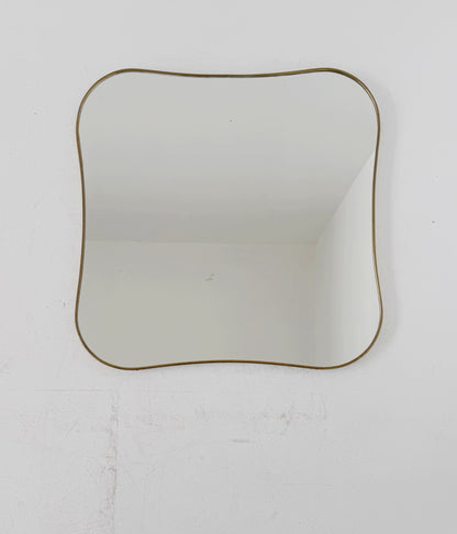Shaped vintage mirror with a gold-tone frame