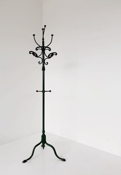Floor coat rack made of dark green painted iron.