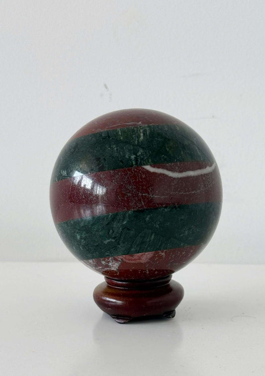 Decorative sphere of polychrome hardstones on a turned wood base