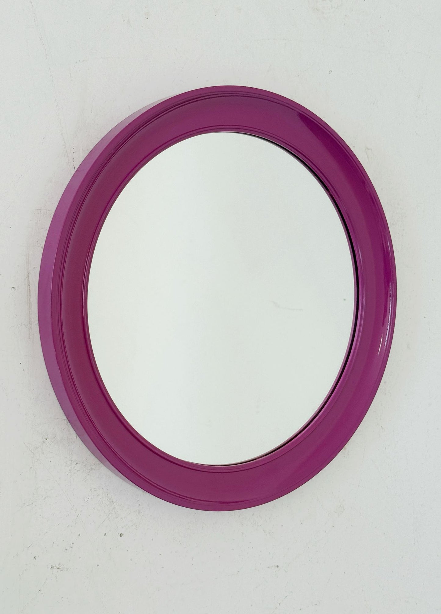 Round mirror with purple plastic frame
