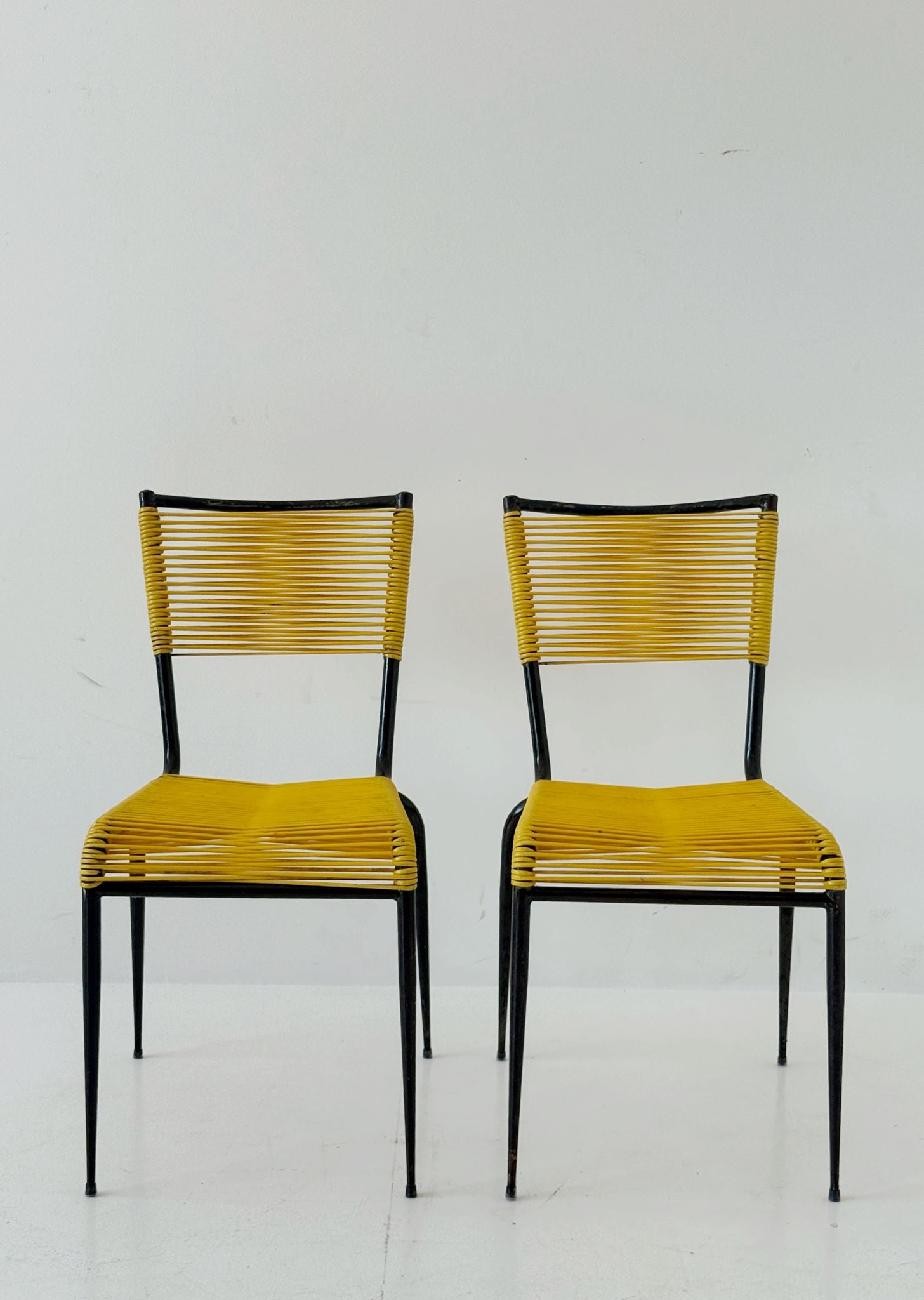 Pair of 1960s design chairs with metal frames and yellow woven detailing