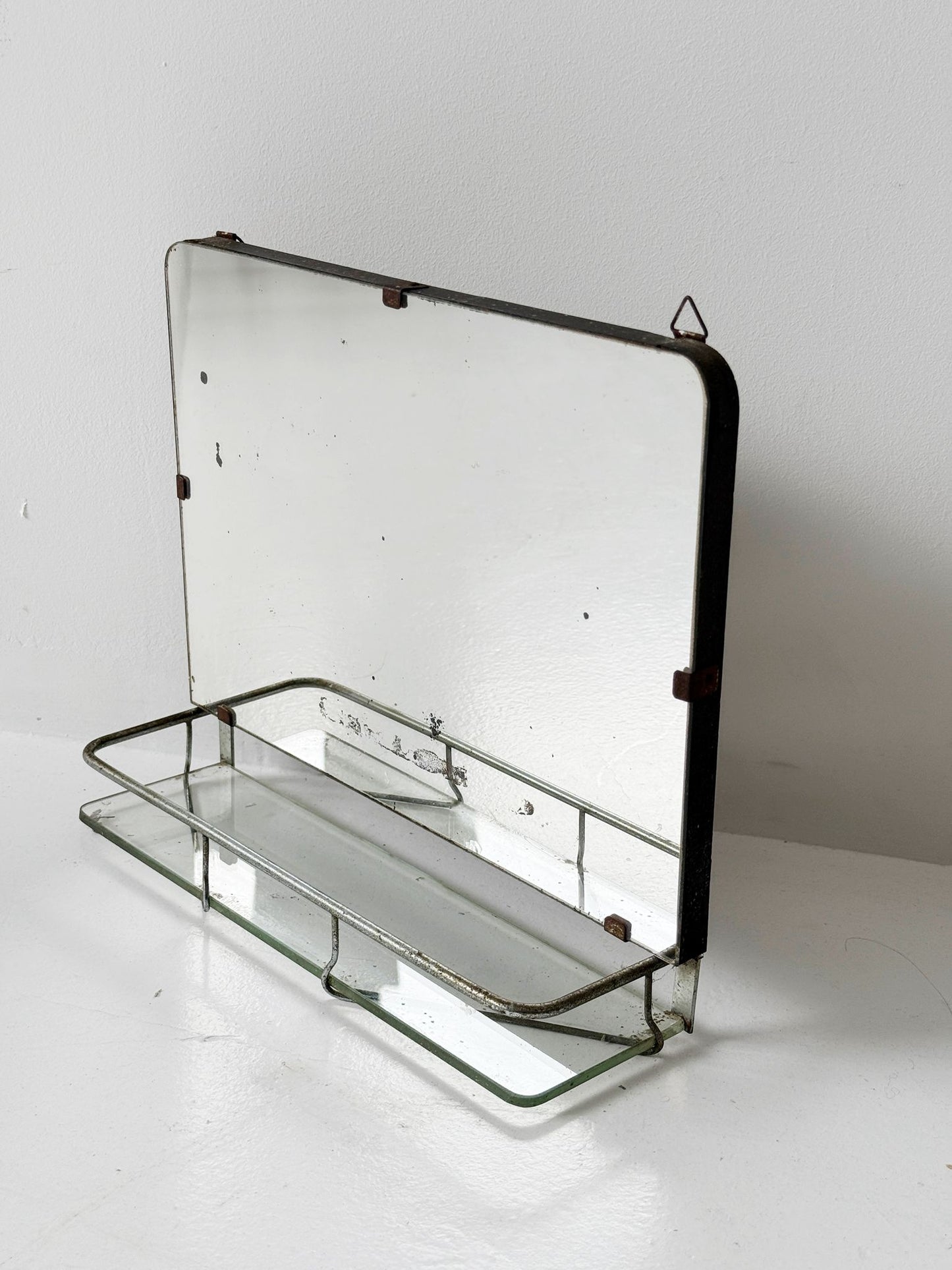 Small wall mirror with glass shelf